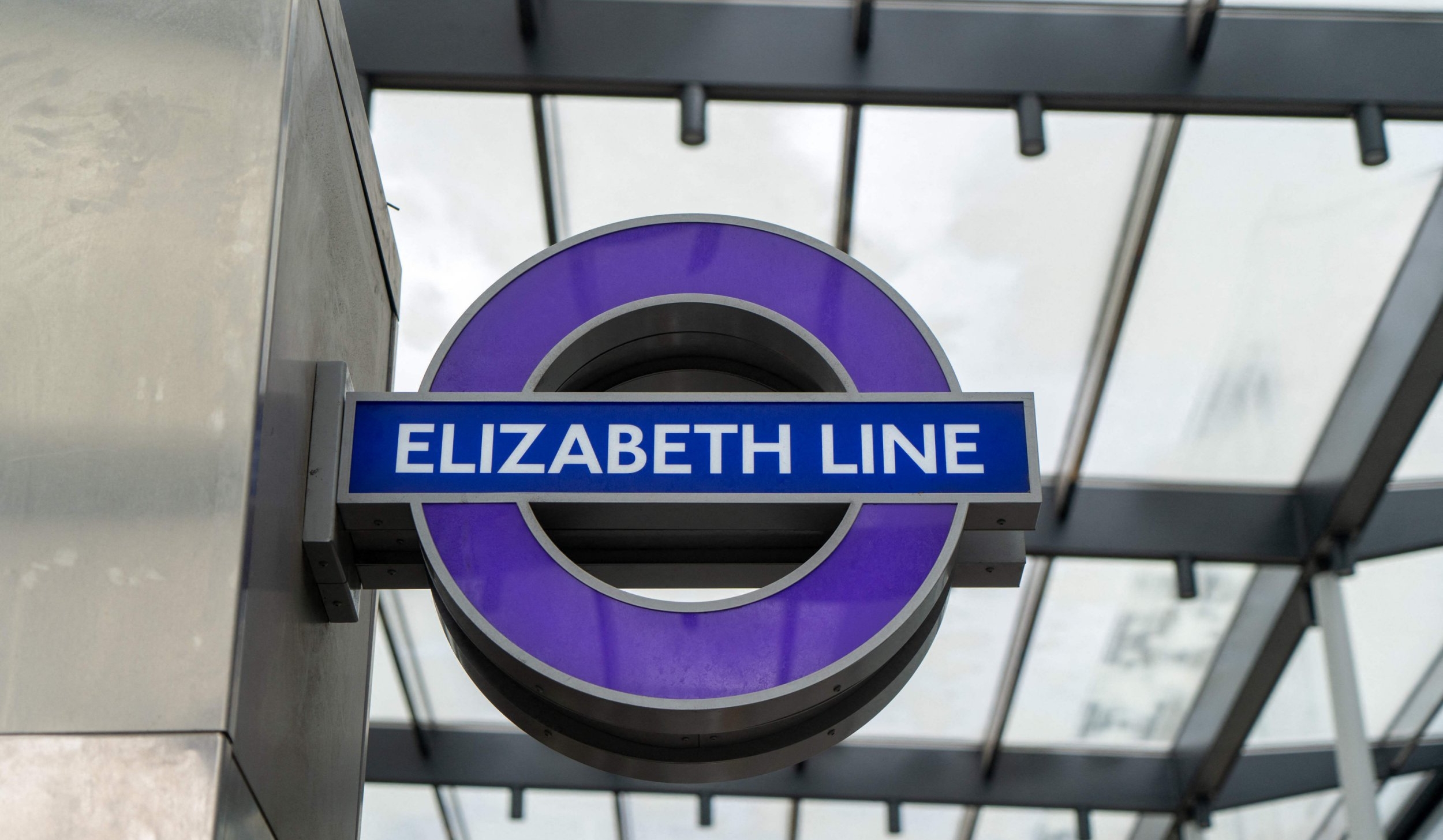 Signs for Transport for London's new Elizabeth Line are pictured at Paddington Station in London on March 13, 2022, before a test run of a train between Paddington station and Woolwich station and back. - The Elizabeth Line, named after Britain's reigning monarch Queen Elizabeth II, has been decades in the planning and making and seeks to add 10 percent to central London's creaking rail capacity. Once opened, Crossrail will run from Reading and Heathrow in the west to Shenfield and Abbey Wood in the east, via 13 miles of new tunnels in central London. (Photo by Niklas HALLE'N / AFP) (Photo by NIKLAS HALLE'N/AFP via Getty Images)